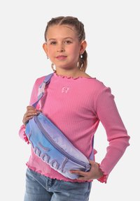 Marsupio con sfumatura viola e blu con testo ricamato, indossato sulla spalla. Modello in maglietta rosa a coste con orli arricciati.