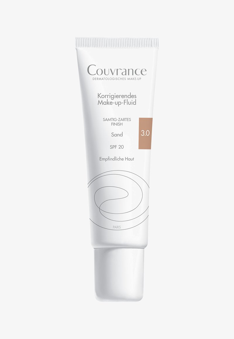 Couvrance corrective makeup fluid in a white tube with a matte finish, features a beige label, offers SPF 20, and is labeled "Sand" 3.0.