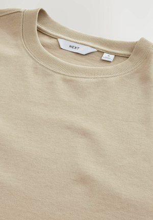 Felpa beige a girocollo realizzata in tessuto texturizzato. Collo e polsini a costine. Etichetta visibile all'interno, con indicazione del marchio e della taglia (M).