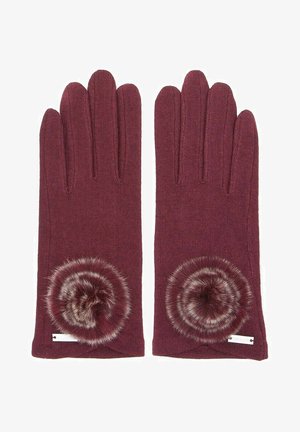 Burgunderfarbene gestrickte Handschuhe mit einem kreisförmigen, fellartigen Pompon-Akzent am Handgelenk. Strukturiert, schmal geschnitten und ohne sichtbare Beschläge.
