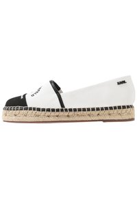 Espadrillas in tela bianca e nera con suola in corda di juta. Presentano una punta arrotondata, accenti cuciti e un logo sul tallone.