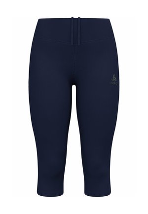 Marineblauwe stretchlegging met een gladde textuur, cropped lengte en platlock naden. Bevat een klein logo detail op de voorkant van de tailleband.