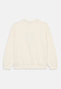 Felpa in cotone di colore bianco sporco, con una vestibilità rilassata, polsini e orlo a costine. Tessuto liscio con design a girocollo.
