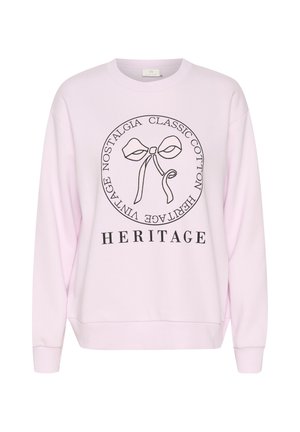 Sweat-shirt rose clair avec un nœud en contour noir et le texte « Classic Cotton Heritage Vintage Nostalgia » en cercle, et « HERITAGE » en dessous.
