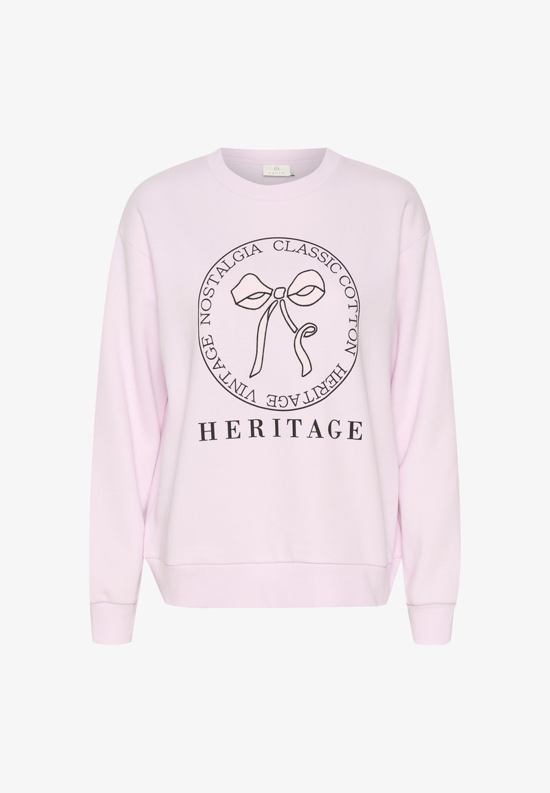Sweat-shirt rose clair avec un nœud en contour noir et le texte « Classic Cotton Heritage Vintage Nostalgia » en cercle, et « HERITAGE » en dessous.