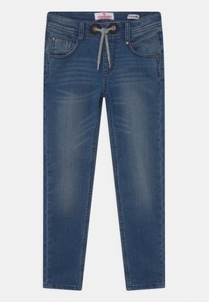 Jeans de mezclilla ajustados en azul con cordón frontal, detalles desgastados en los muslos y diseño estándar de cinco bolsillos.