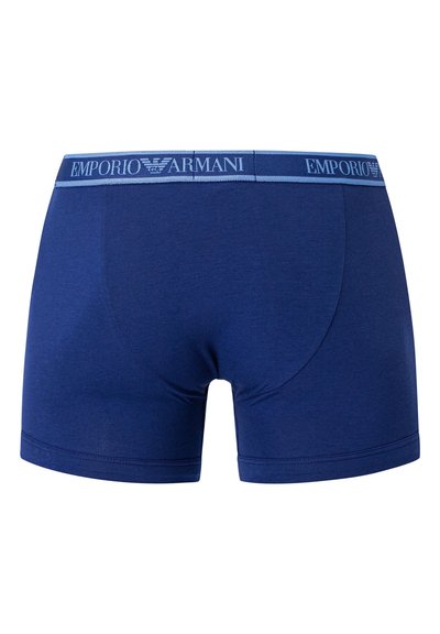 Navy blue boxer shorts made of soft fabric, featuring a contrasting blue waistband with "Emporio Armani" logo stitched on the front.
