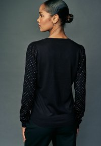 Next Pullover - black sparkle