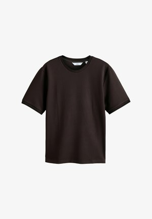 Black short-sleeve textured fabric T-shirt with crew neck, relaxed fit, and a small white label inside the collar.