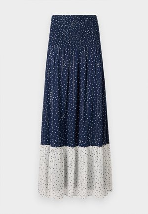 Navy skirt with white polka dots, featuring a smocked waistband and a tiered design with a contrasting solid white lower section.