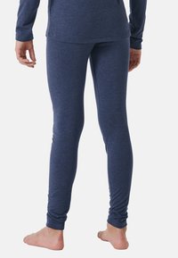 Navy blue, stretchy leggings made of soft material, featuring a snug fit and gathered ankle cuffs. Displayed from the back, worn barefoot.