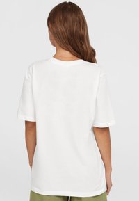 White cotton t-shirt with short sleeves, a round neckline, and a relaxed fit. Smooth texture without patterns or visible hardware details.