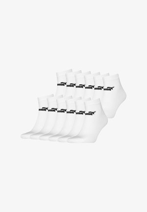 White ankle socks made of cotton blend, featuring black Puma logo, ribbed cuff, and smooth texture, arranged in two rows of six pairs.