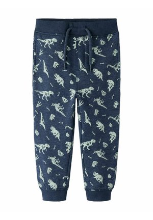 Survêtements bleu marine avec un imprimé dinosaure et fossiles en vert clair, dotés d'une taille élastique et d'un cordon de serrage, fuselés aux chevilles.
