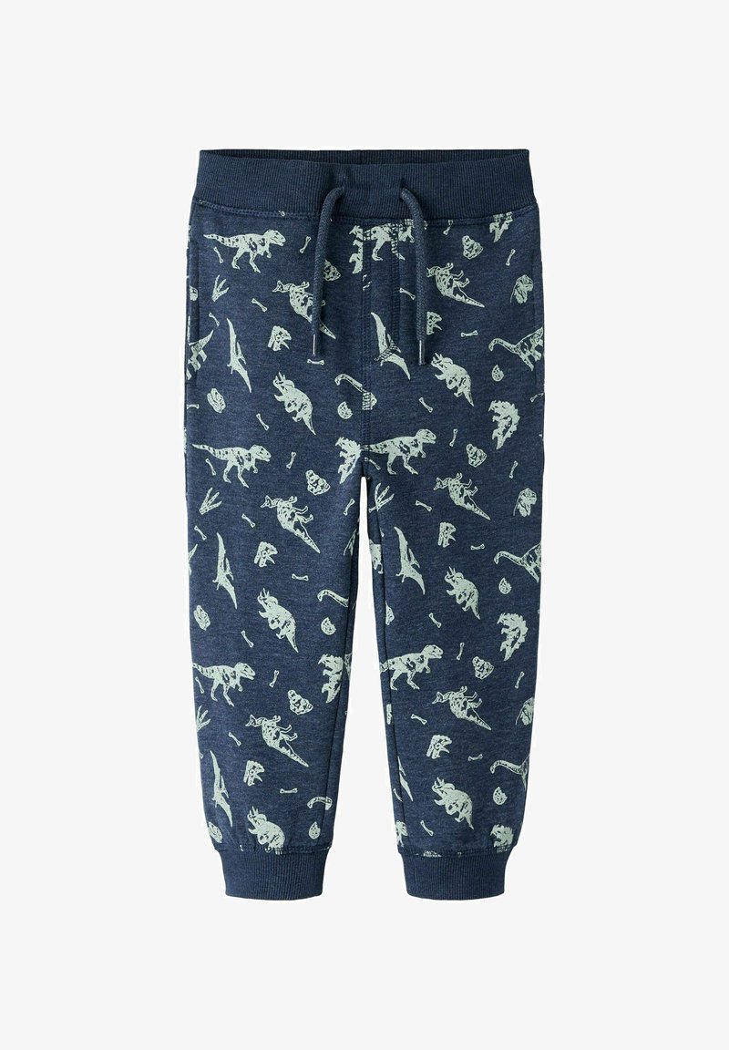 Navy-coloured collegehousut, joissa on vaaleanvihreä dino- ja fossiilikuosi, elastinen vyötärö ja nyöri, kapenevat nilkoissa.