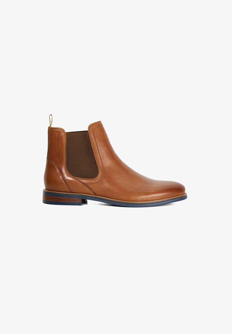 Brown leather Chelsea boot with elastic side panels, rounded toe, and a flat sole. Features a pull tab on the heel and wooden accent on the sole.