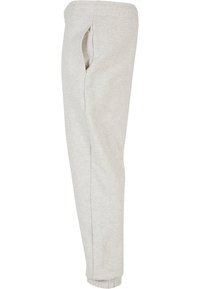 Grå sweatpants av mjuk bomullsblandning, med tapered passform, elastisk midja och muddar vid anklarna. Inkluderar sidofickor.