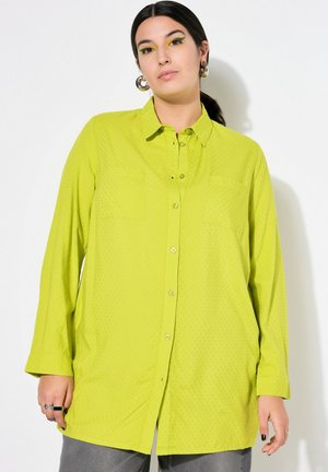Limoengroene button-up shirt van gestructureerde stof, met twee borstzakken, lange mouwen en een losse pasvorm. Voorzien van een klassieke kraag en knoopdetails.