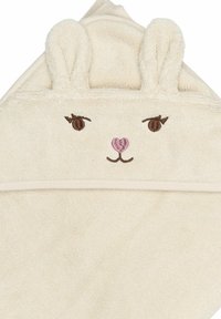 Håndklæde med kaninmotiv, fremstillet af blødt beige frotté. Har plyssede ører, broderede ansigtsdetaljer i brunt og pink, samt en hætteform.