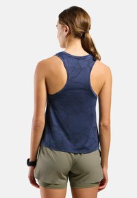 Navy tank top with a textured pattern and a racerback design, paired with light green shorts, showcasing a relaxed fit and sporty style.