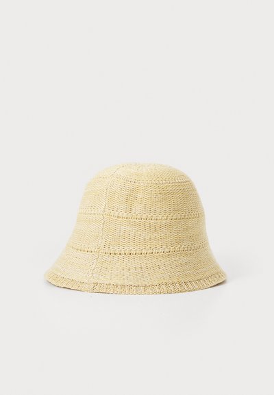 Bucket hat made of light beige woven material, featuring a rounded crown and a wide, downward-sloping brim with textured stripes.