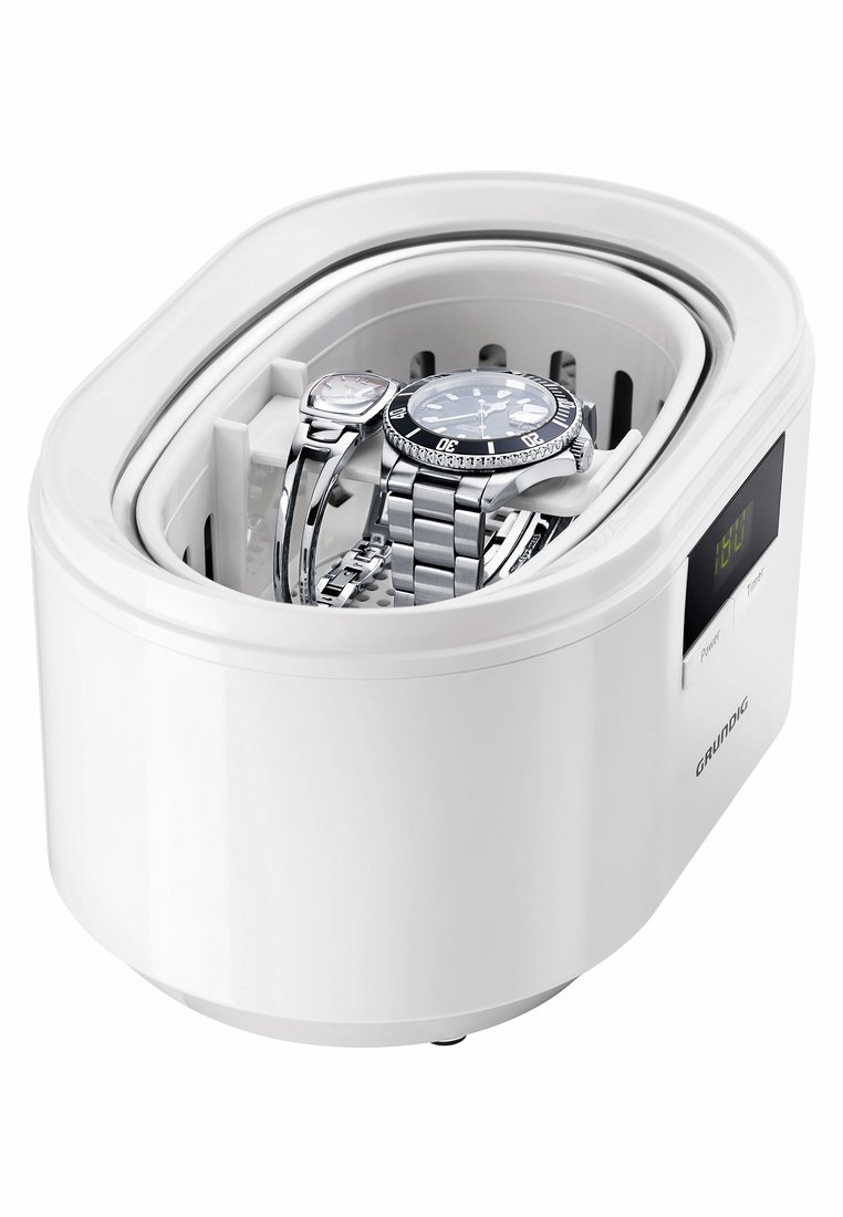 Nettoyeur ultrasonique avec affichage numérique contenant deux montres en métal à l'intérieur d'un boîtier en plastique blanc.