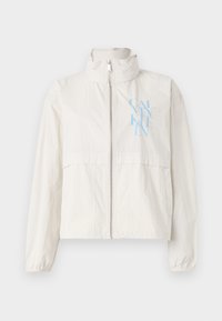 Lightweight, cream-colored jacket in a smooth fabric with a high collar, zipped front, and a blue logo on the left chest.