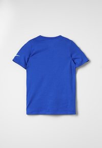 Blue cotton T-shirt with short sleeves, round neck, smooth texture, and white accent detail on the left sleeve. Back view shown.