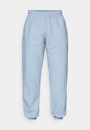 Pantalon de jogging bleu clair avec une taille élastique, en tissu texturé, jambes fuselées et un petit logo cousu sur la couture latérale.