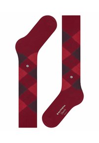 Calze argyle rosse con motivi a diamante in rosso scuro e borgogna, orlo a coste e piccolo logo sulla pianta. Realizzate in tessuto morbido.