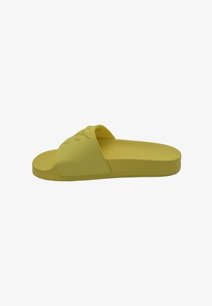 Infradito in gomma gialla con una fascia ampia caratterizzata da un design testurizzato. Suola piatta, forma minimalista, adatta all'uso quotidiano.