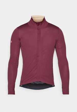Maglia da ciclismo a maniche lunghe di un profondo bordeaux, realizzata in tessuto morbido con colletto alto, zip frontale e vestibilità aderente. Presenta un orlo arrotondato.