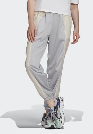Heledad hallhalli tracksuit' püksid kreemjate külgpaneelidega, elastsete paeladega ja brodeeritud logoga. Sile, kerge materjal ja avar lõikega.