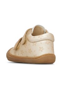 Scarpe per bambini color beige con un motivo floreale, in morbida pelle, con strap in velcro e suola in gomma testurizzata per aderenza e flessibilità.