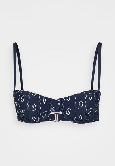 Tengerészkék bikini felső fehér pöttyös és virágmintás díszítéssel, alátámasztott kosarakkal, állítható pántokkal és fémkapcsolóval.