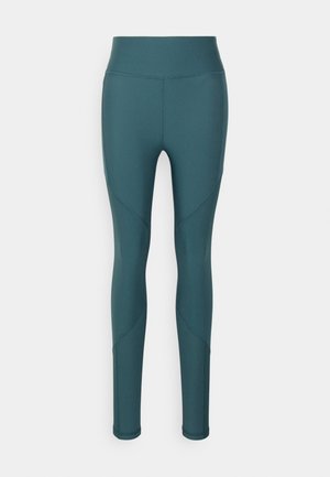 Leggings teal cu talie înaltă, realizate dintr-un material elastic, cu detalii de cusături curbe și o textură netedă pentru confort în timpul mișcării.