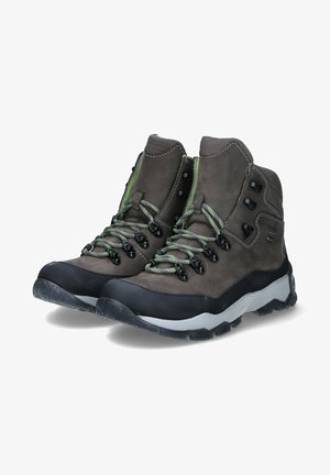 Brown leather hiking boots with green laces and black hardware. Textured upper, rubber toe cap, and a multi-patterned outsole.