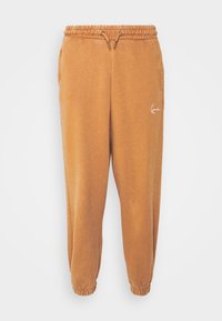 Brown sweatpants with elastic waistband and drawstring. Cuffed hems and a small white logo accent on the side. Soft, textured fabric.