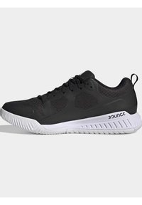 Black athletic shoes with a breathable mesh upper, white sole, textured accents, and a curved design. Features include a lace-up closure and logo.