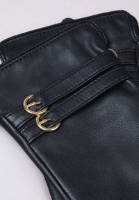 Black leather gloves featuring two gold-tone buckles and stitched detailing, with a smooth texture and structured design.