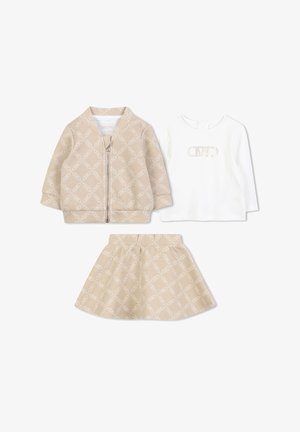 Kolme lasteriiete komplekt: beež mustriga tõmbluku jao, valge pikka varrukaga särk logoga ja sobituv beež seelik.