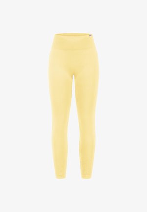Naadloze gele legging met hoge taille en geribde tailleband, aansluitende stijl die tot aan de enkels reikt, zachte rekbare stof.