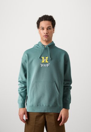 Hooded sweatshirt in teal with a front pocket. Features a colorful graphic logo, ribbed cuffs, and a relaxed fit design.