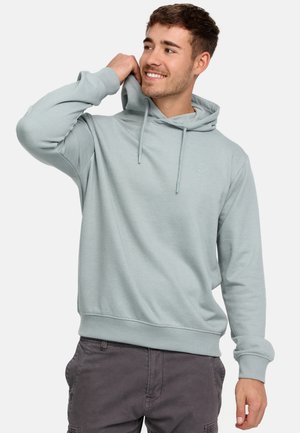 Light blue hoodie with a drawstring hood, ribbed cuffs, and hem. Features a subtle logo on the chest and a relaxed fit. Soft fabric texture.