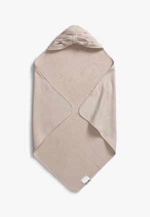 Asciugamano con cappuccio beige realizzato in morbido tessuto peloso. Presenta un motivo a fiocco attorcigliato nella parte superiore e un piccolo etichetta del marchio sul bordo.