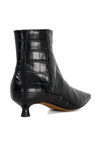 Black ankle boot made from textured, crocodile-patterned material. Features a pointed toe and a short kitten heel.