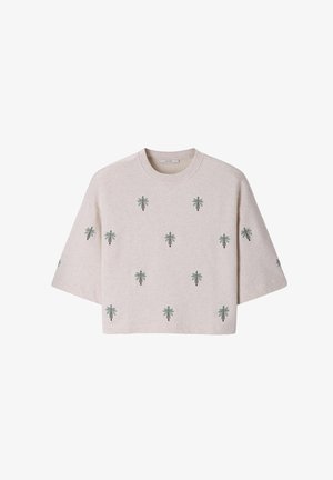 Pull beige clair à manches courtes avec des motifs de palmiers verts répartis uniformément sur le devant et les manches, avec un col rond.