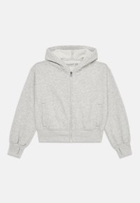 Sweatshirt zippé gris en tissu texturé, avec capuche et poches latérales. Présente des bords-côtes aux poignets et un design de bas échancré. Intérieur doublé.