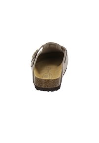 Light beige slide sandal with a cork footbed, soft suede upper, adjustable strap, and textured rubber sole. Back view.