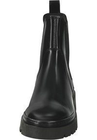 Schwarze Chelsea-Stiefel mit glänzender Oberfläche, elastischen Seiten und einer dicken schwarzen Sohle. Sie verfügen über eine Zuglasche auf der Rückseite für ein einfaches Anziehen.